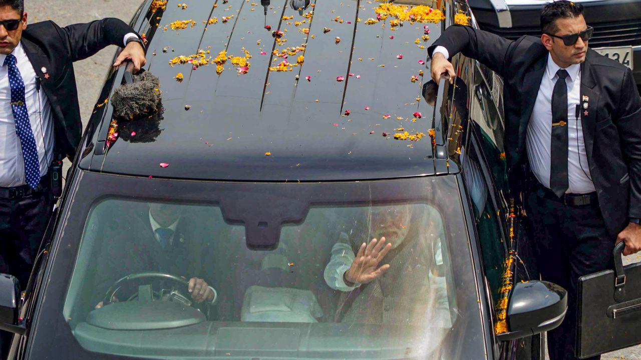 Two Security guards guarding Prime Minister Narendra Modi's car during a roadshow, in Varanasi.